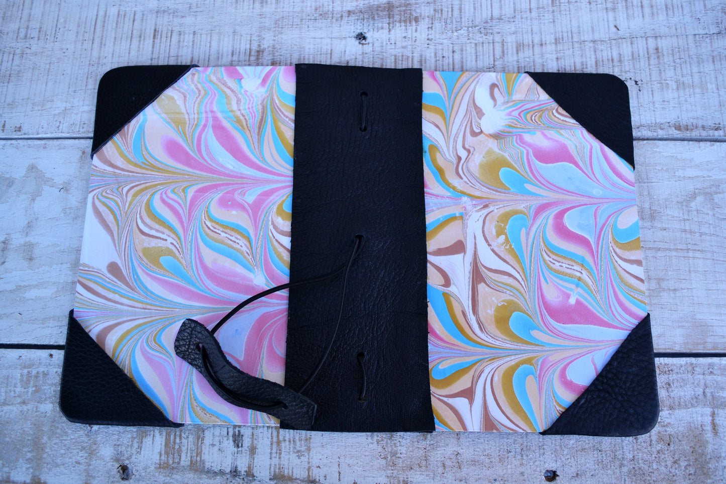 4 marbled notebooks inside and leather bound journal