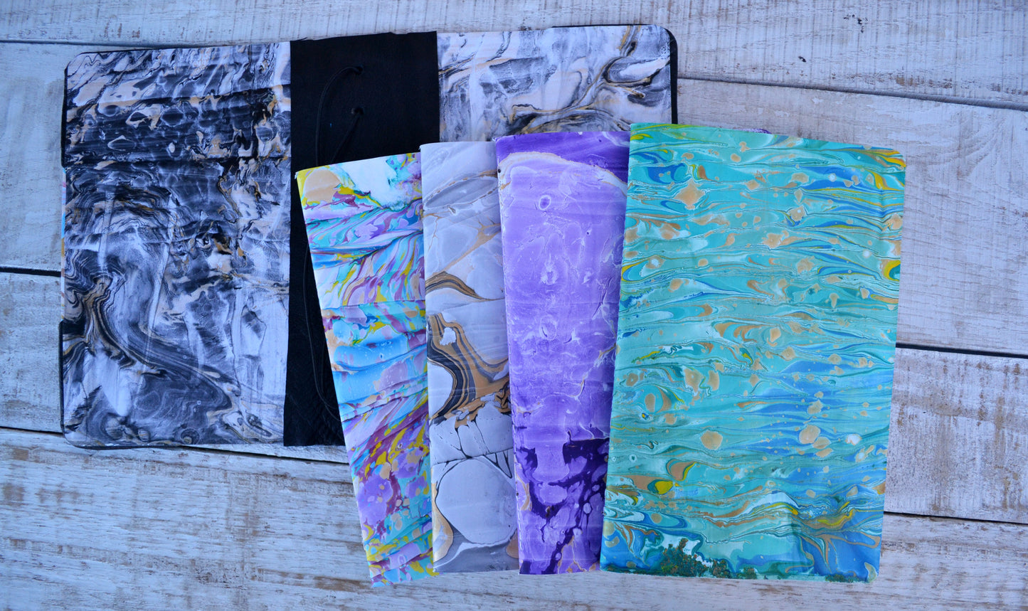 4 marbled notebooks inside and leather bound journal