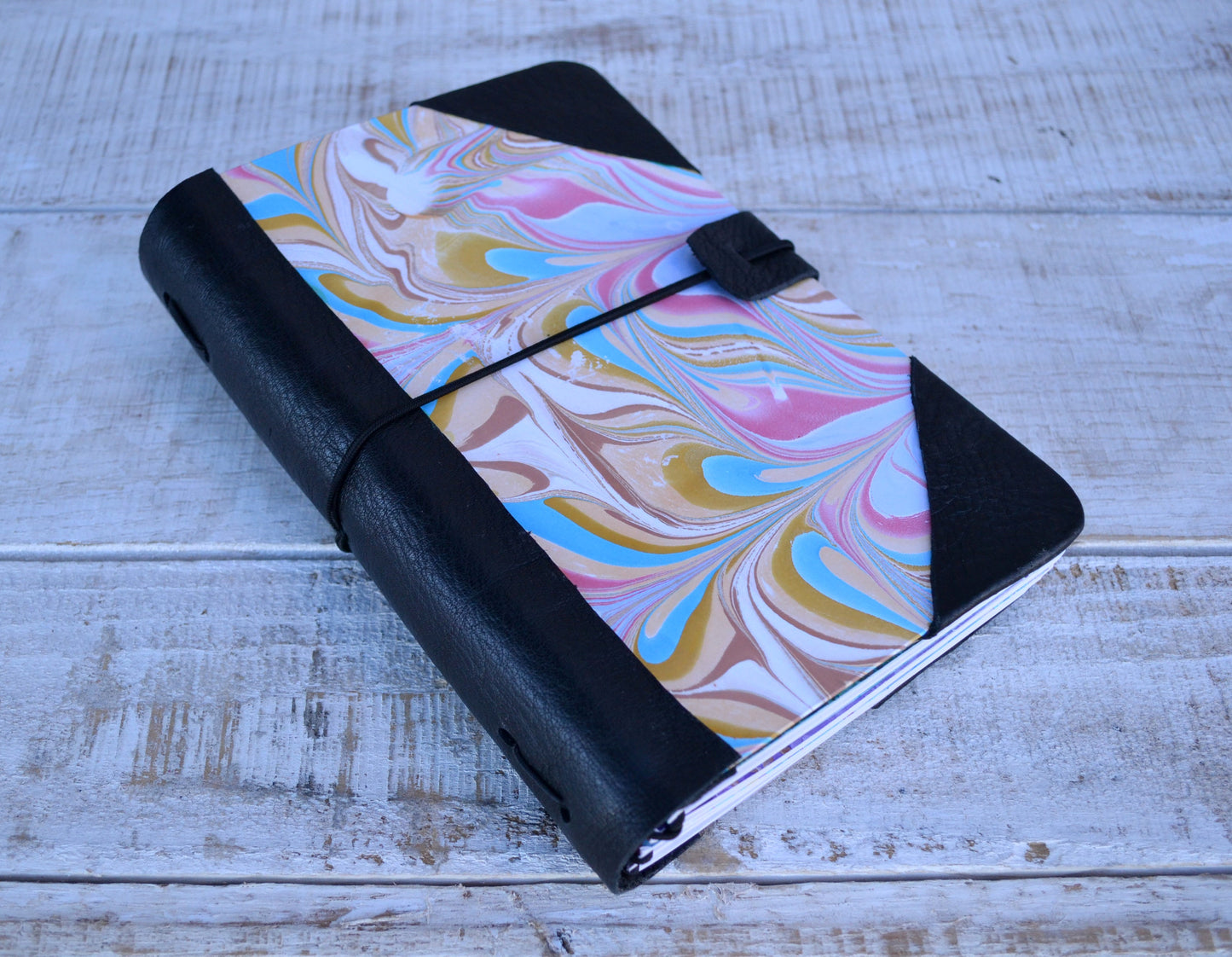 4 marbled notebooks inside and leather bound journal